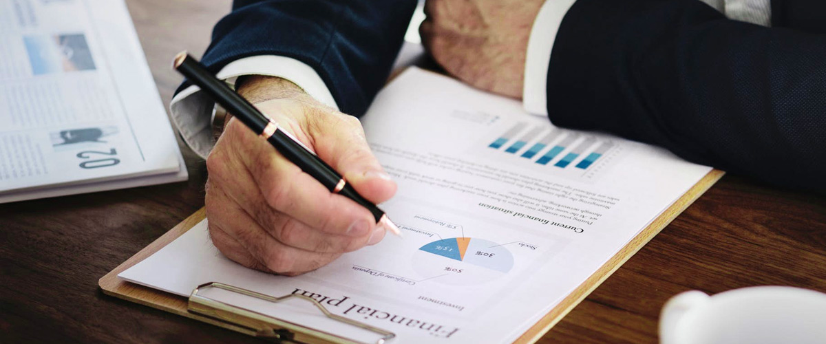 F/X Glossary: Business man with charts at desk